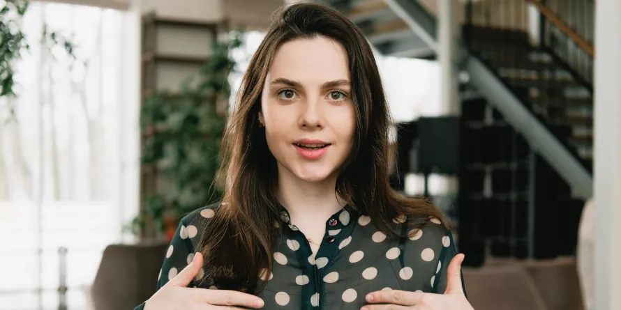 Woman facing camera and using sign language to communicate