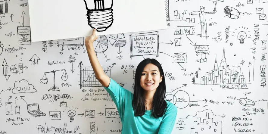 East Asian young woman holding up a sign