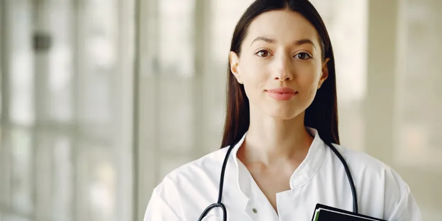 Young woman doctor looking at the camera