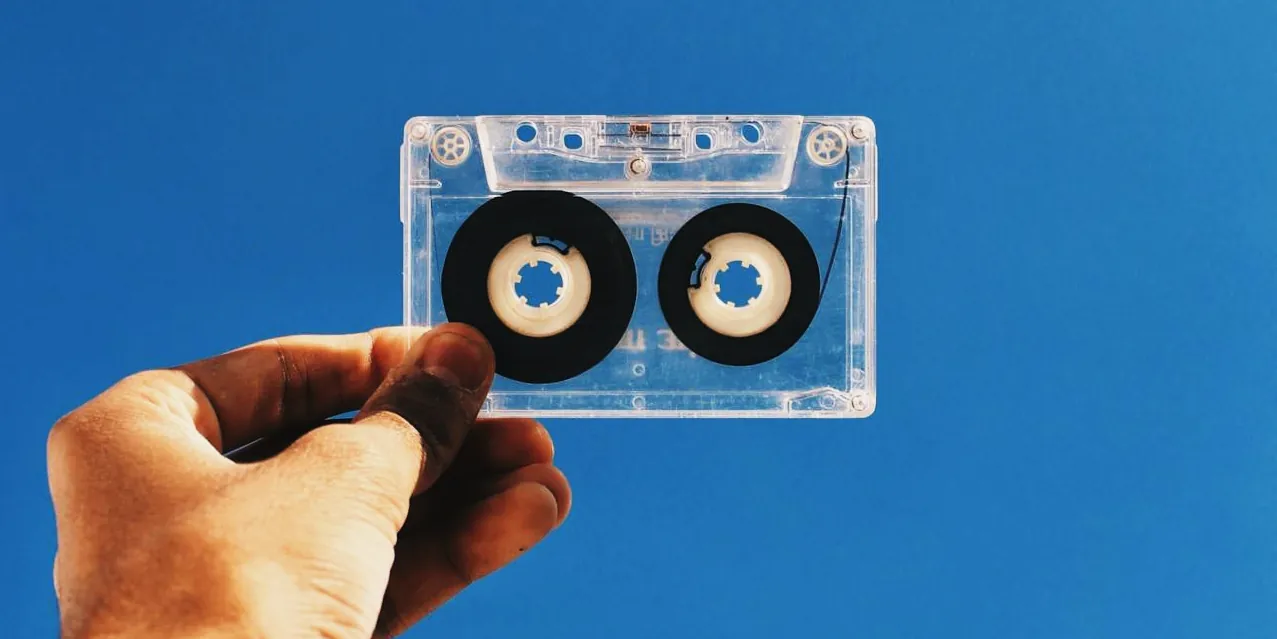 Analogue tape held up to a brught blue background