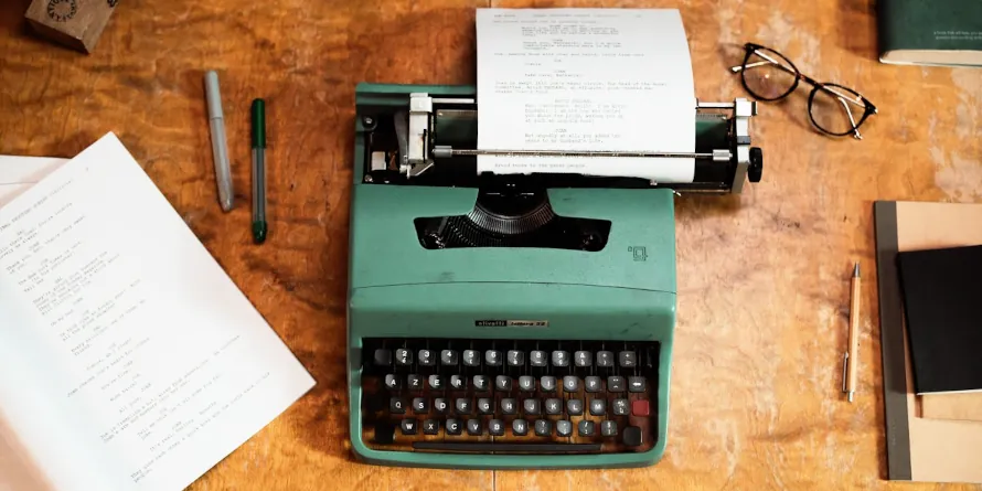 Typewriter on a desk with some papers